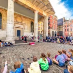 London Covent Garden a street performer surrounded by watchers