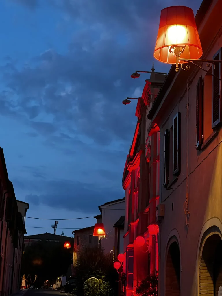 a late sunset on a street with red street lights, making the whole scene dark red