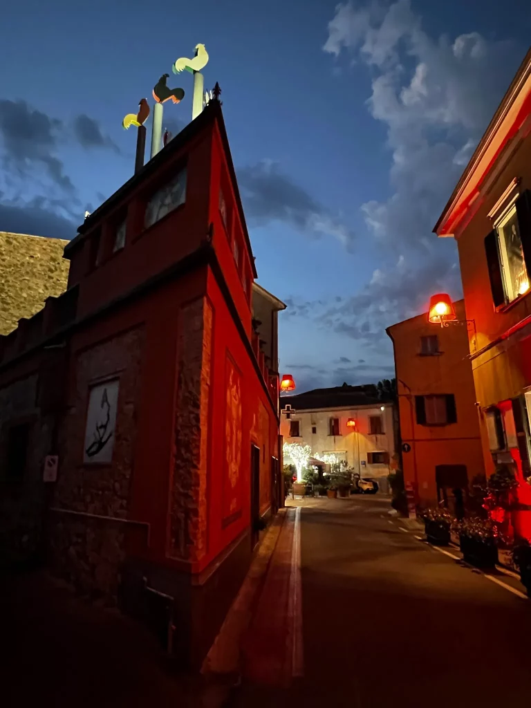a late sunset on a street with red street lights, making the whole scene dark red