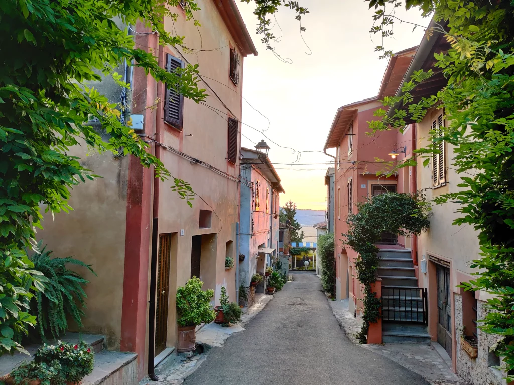 A small street at late afternoon, coloured in different orange, pink, red variations