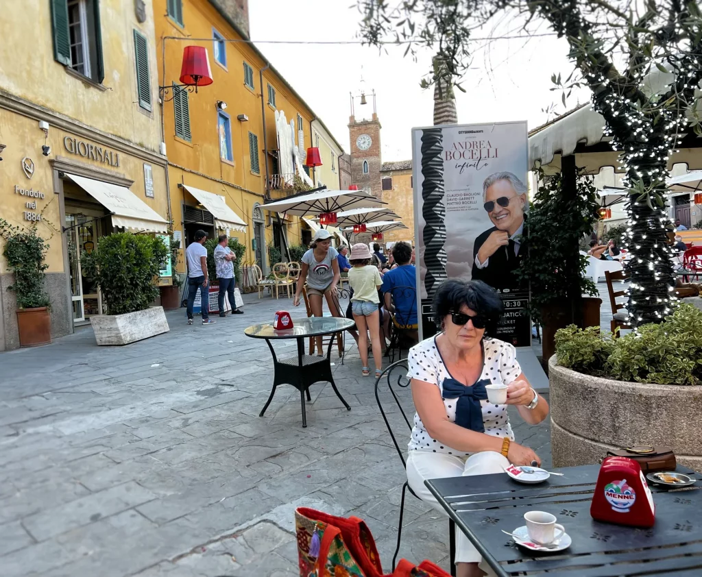 a closer view of the communal area, with a lady in the front view and other people enjoying the afternoon around