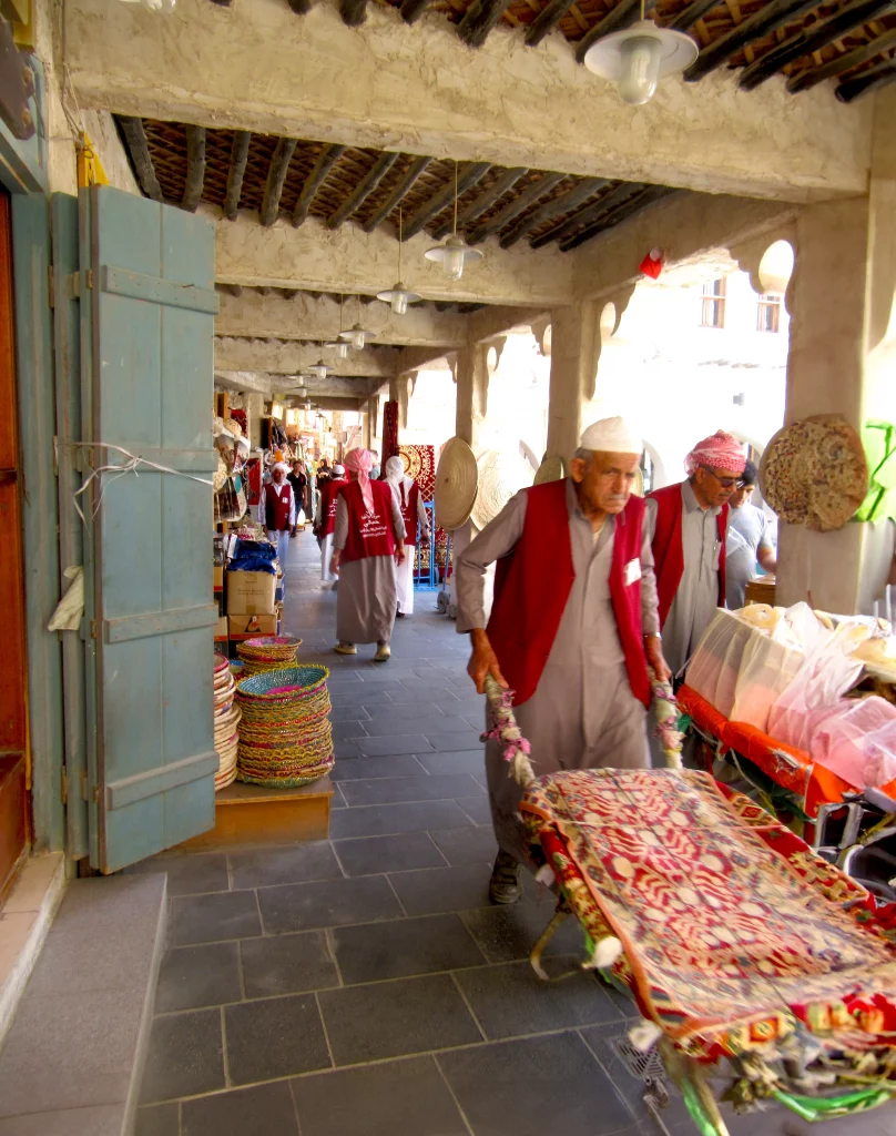 Qatar old town, day, bazar area, wheelbarrow transporters moving merchandise