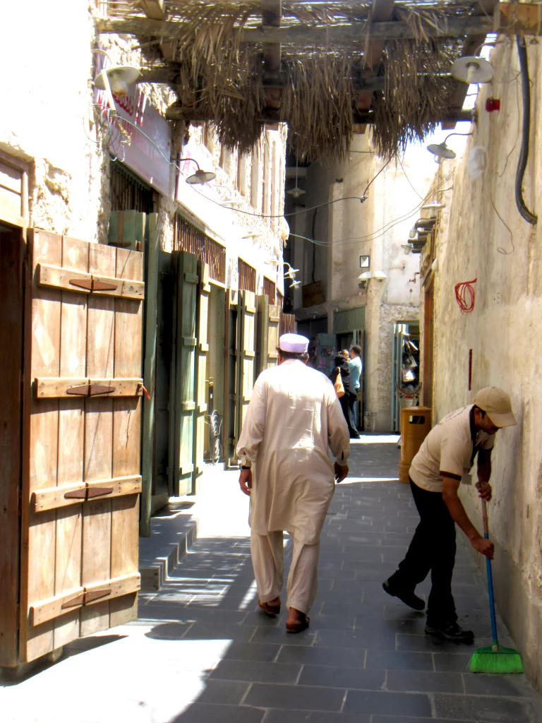 Qatar old town, day, small street, people walking, cleaning