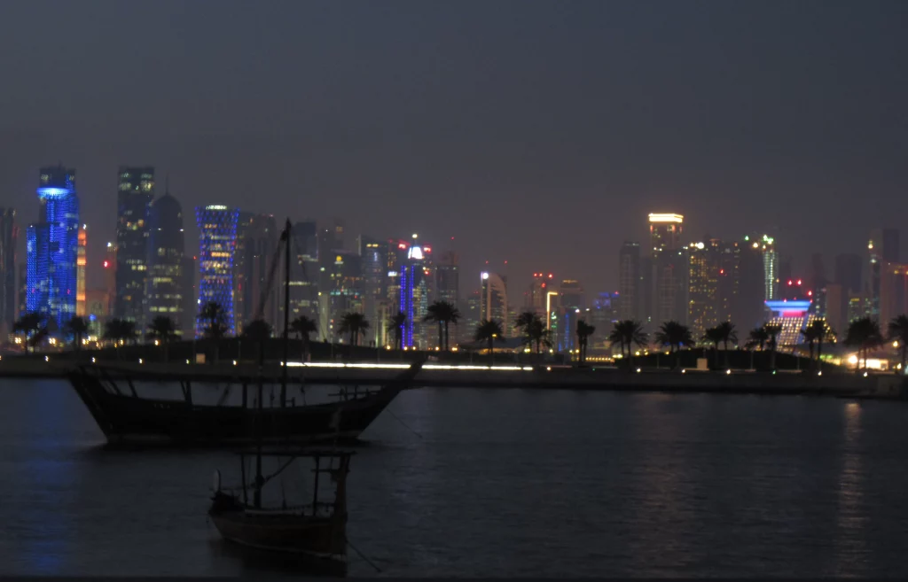 a view of the new city line from old town, with coloured skyscrapers at sunset