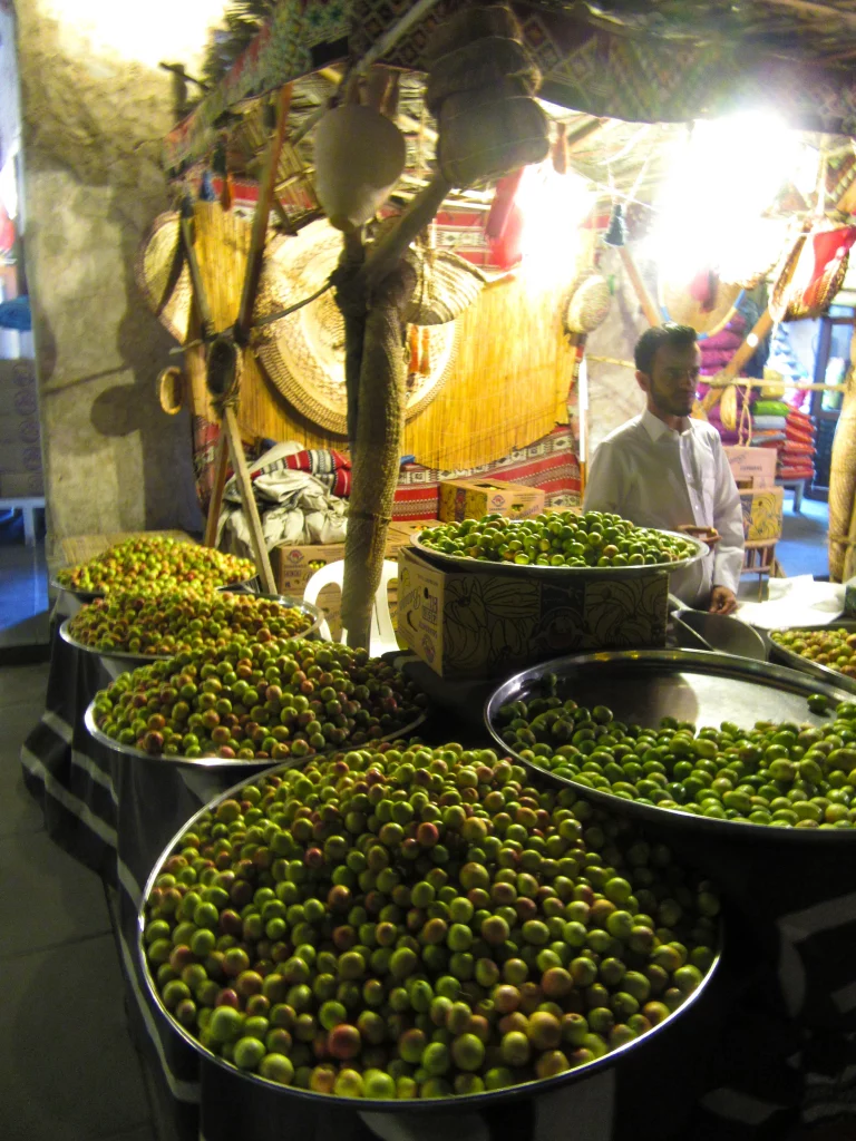 Qatar old town, night, bazar area, a olive merchant with loads of olives in front