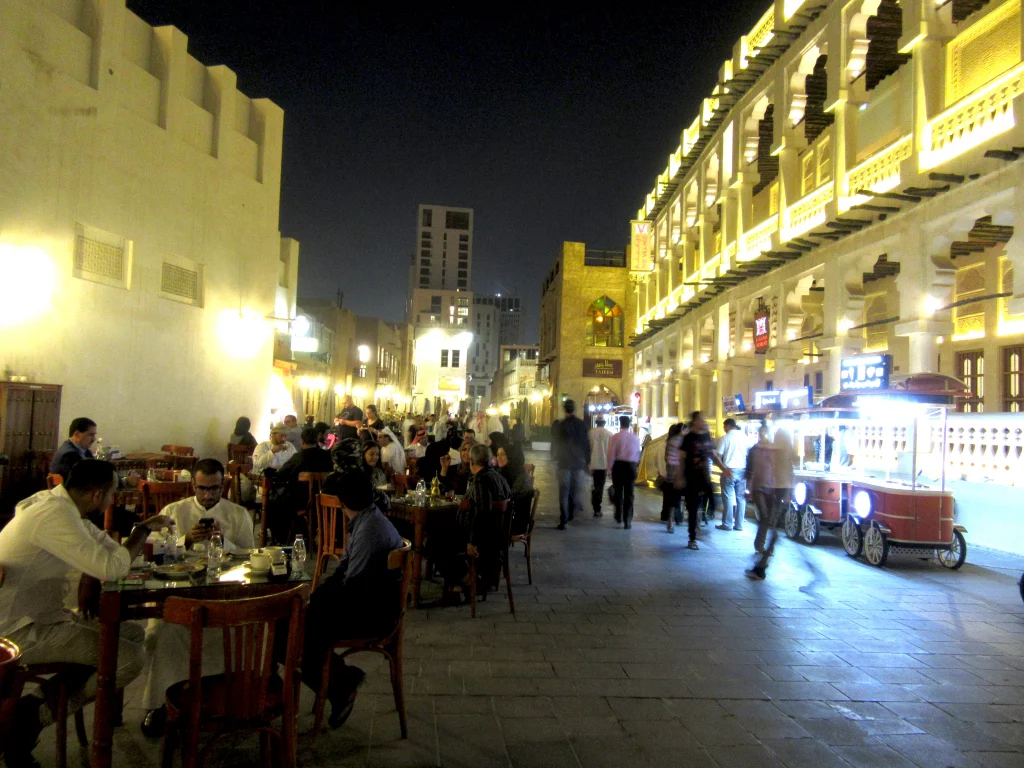 Qatar old town, night, many people having food.