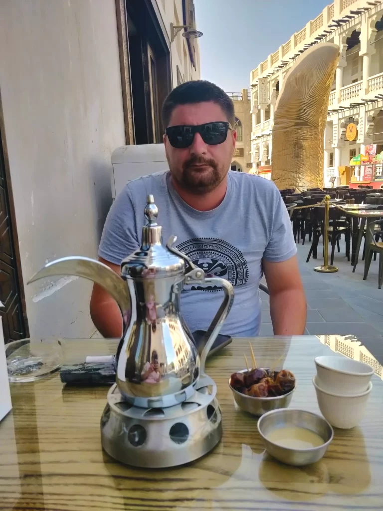 Dodo at a table enjoying coffee