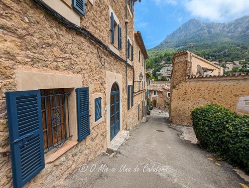 another street shot, with houses on one side and hills on the far plane