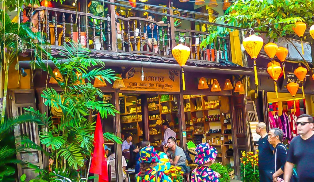 The front of a tea shop with people sitting at tables enjoying drinks