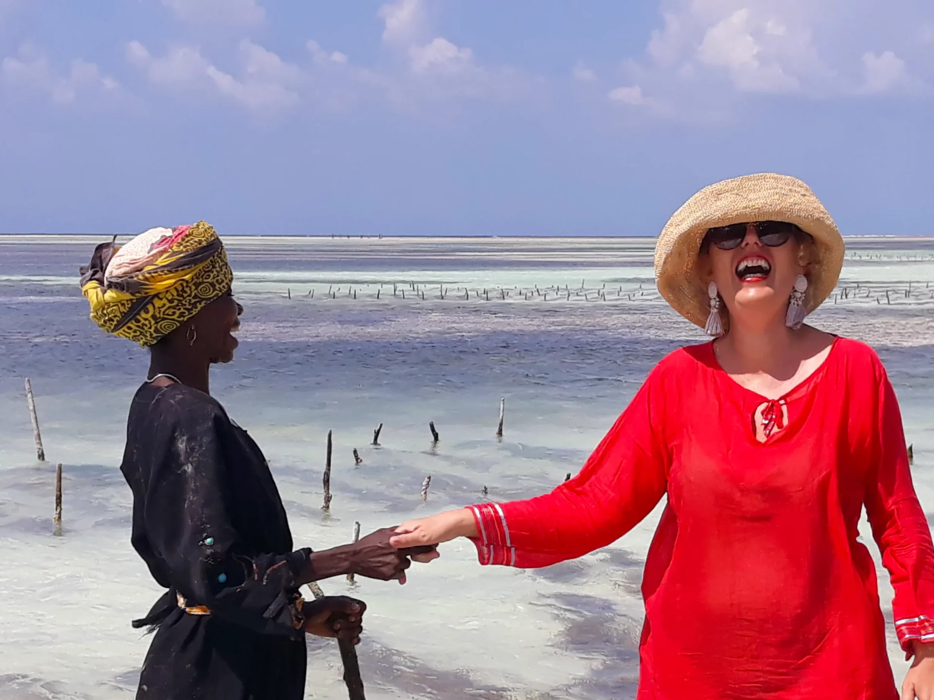 The worker from the farm holding hand with Alina and both laughing.
