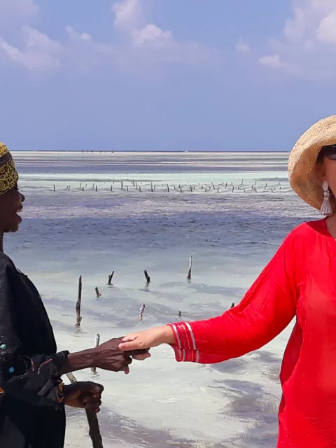 The worker from the farm holding hand with Alina and both laughing.