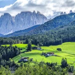 A wide shot from the dolomites with villas on the hills