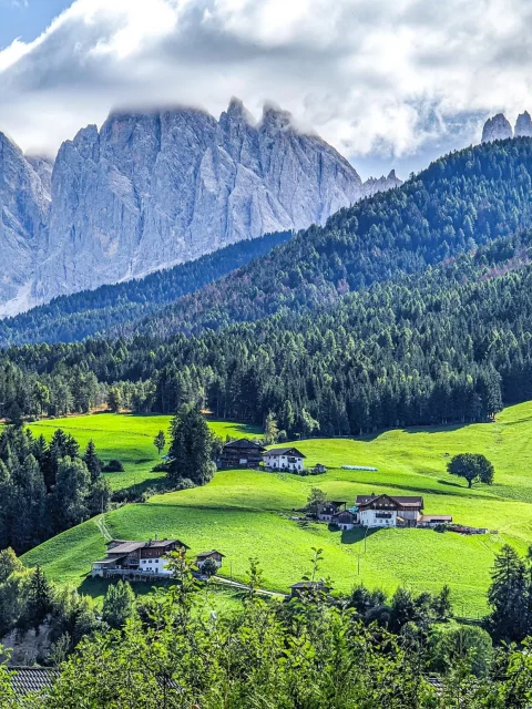 A wide shot from the dolomites with villas on the hills