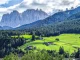 A wide shot from the dolomites with villas on the hills