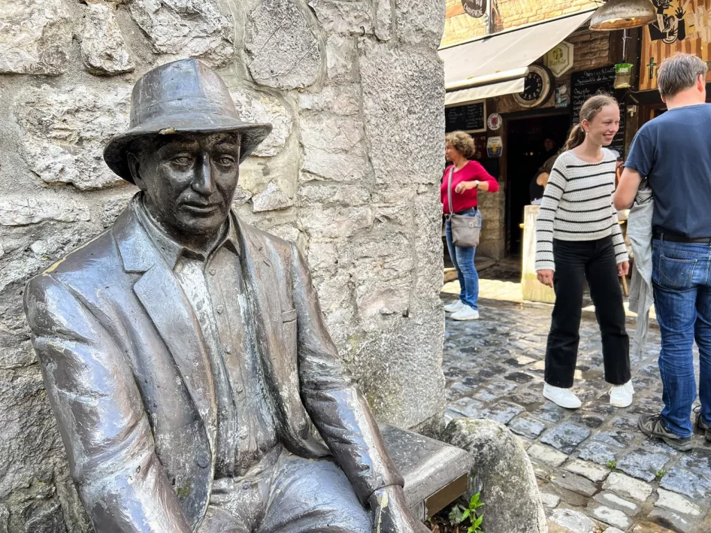 Belgium Durbuy statue of a person sitting on a bench