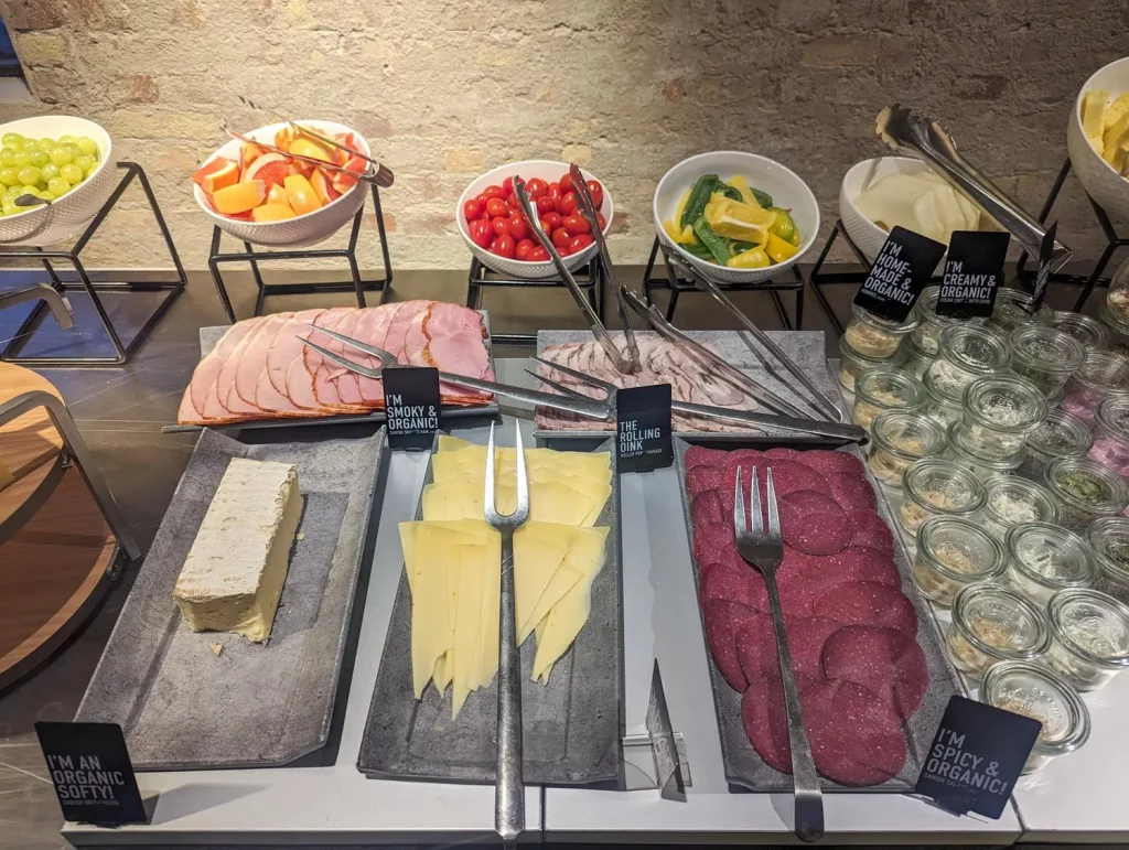 Denmark, a shot of a display for breakfast food, with multiple meats, cheeses, jars with organic food.