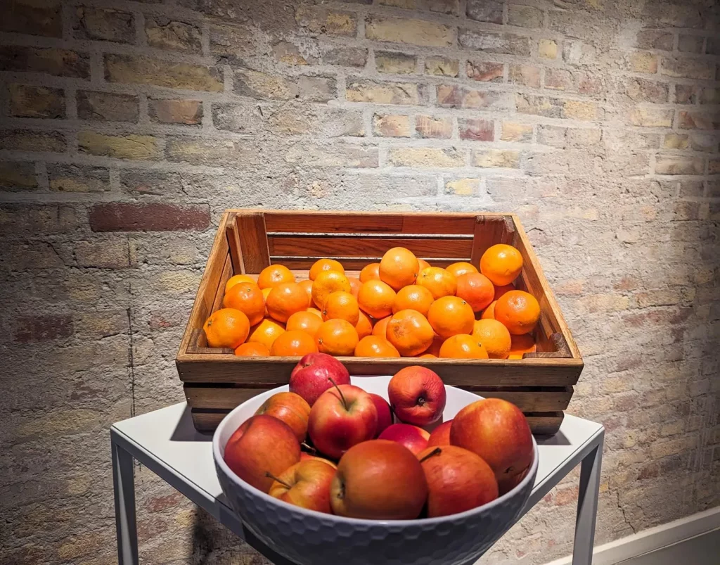Denmark, a closeup of baskets of oranges and apples at breakfast